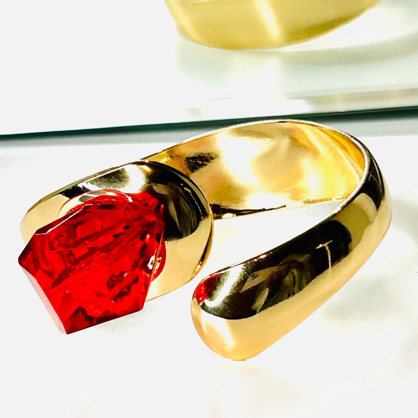 Fashion gold cuff bracelet with red stone.