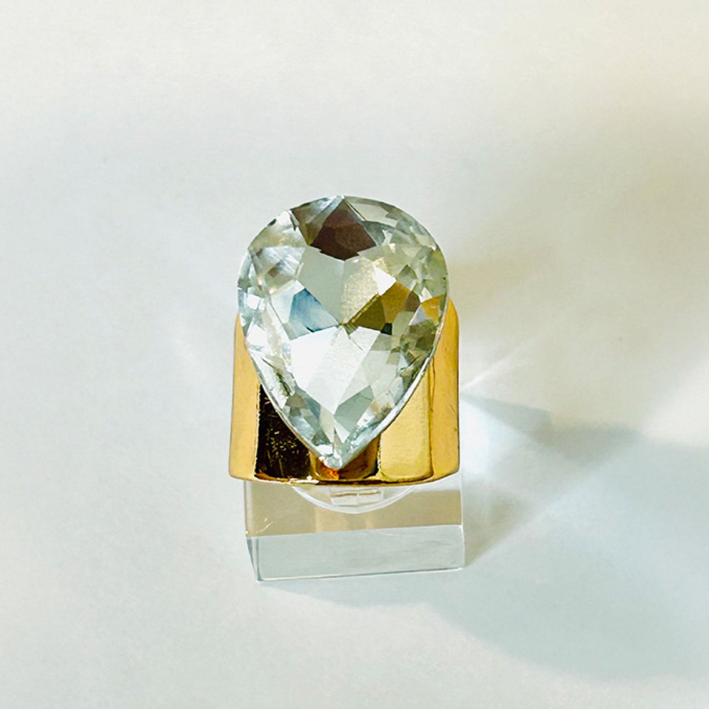 Modern gold ring with a large crystal stone.