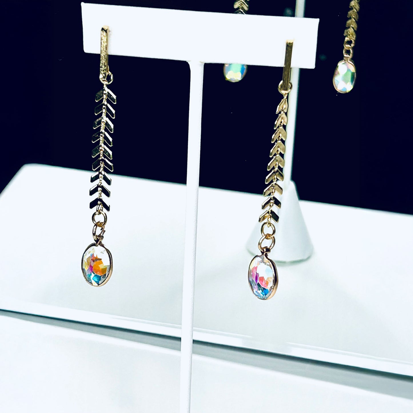 Fashion dangle earrings with transparent multicolor tear drop stones.