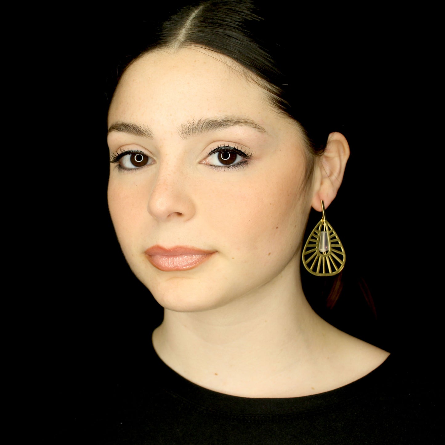 Fashion geometrical gold earrings with crystal at the center.