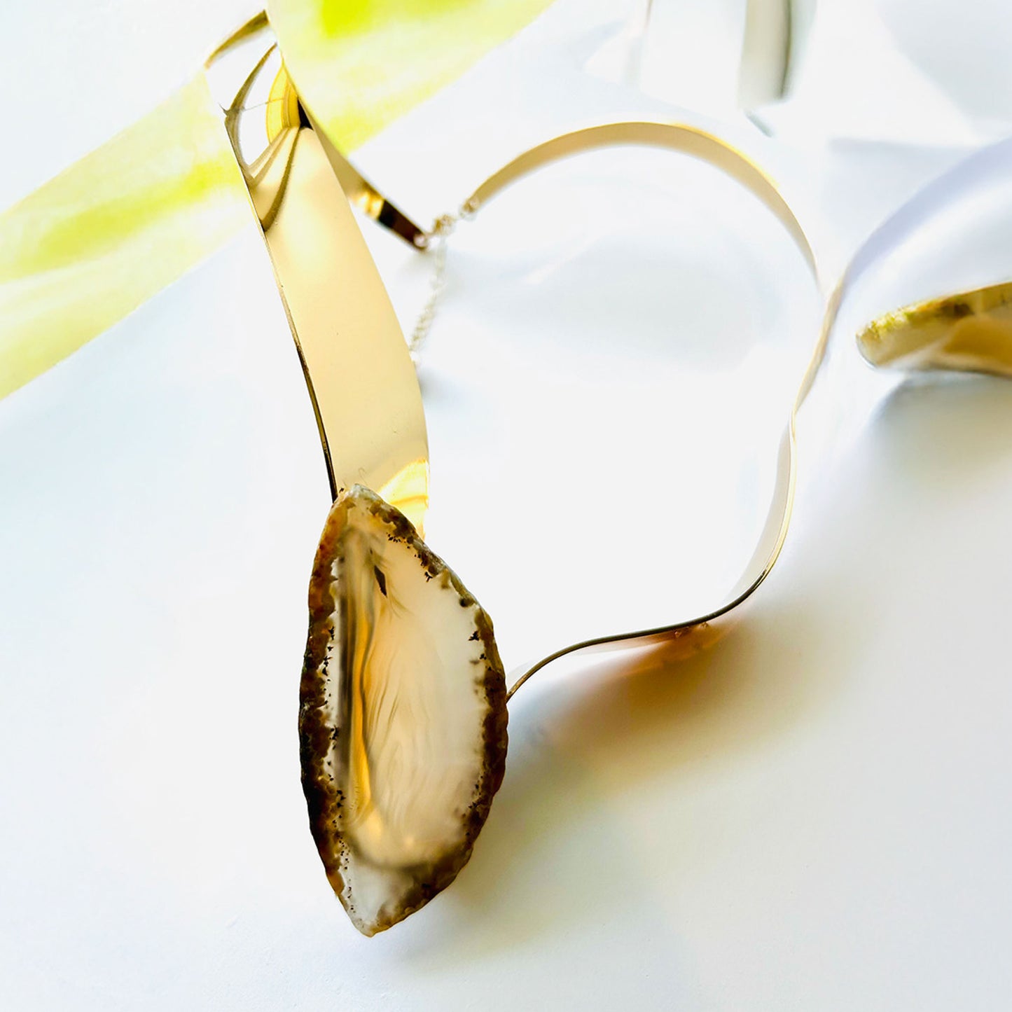 Gold cuff choker necklace with a leaf beige natural glass stone.