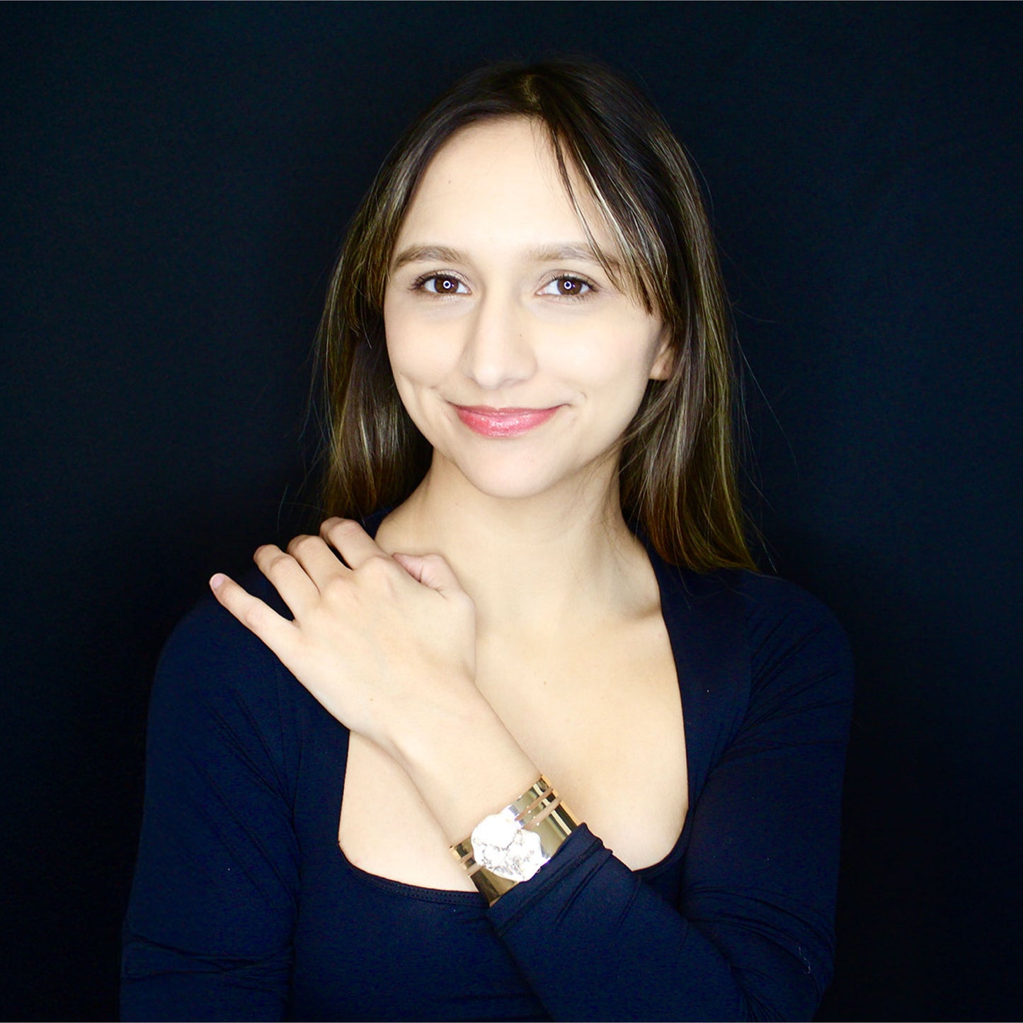 Fashion cuff gold bracelet with a natural white brown spots stone.