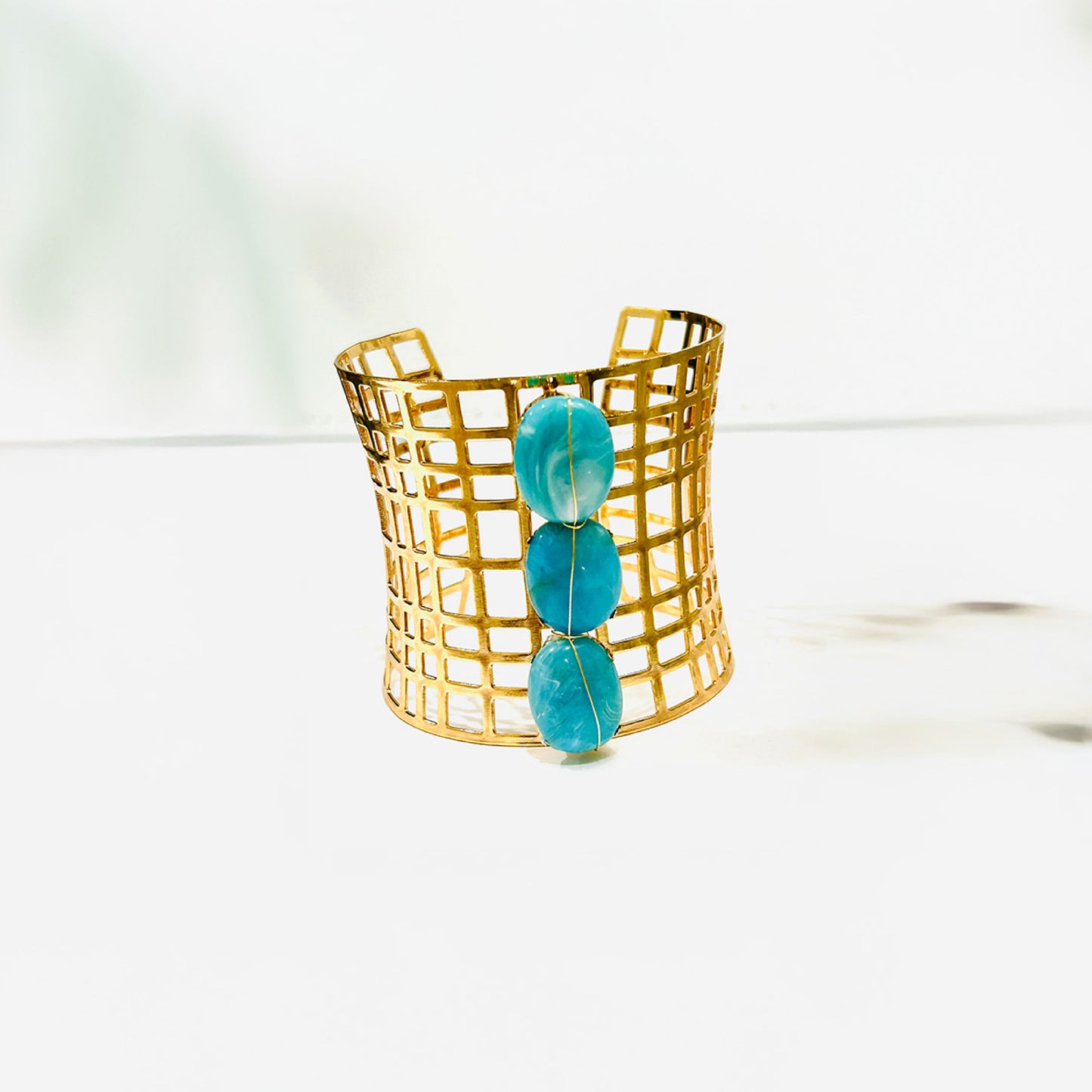 Fashion cuff gold bracelet with 3 turquoise beds.