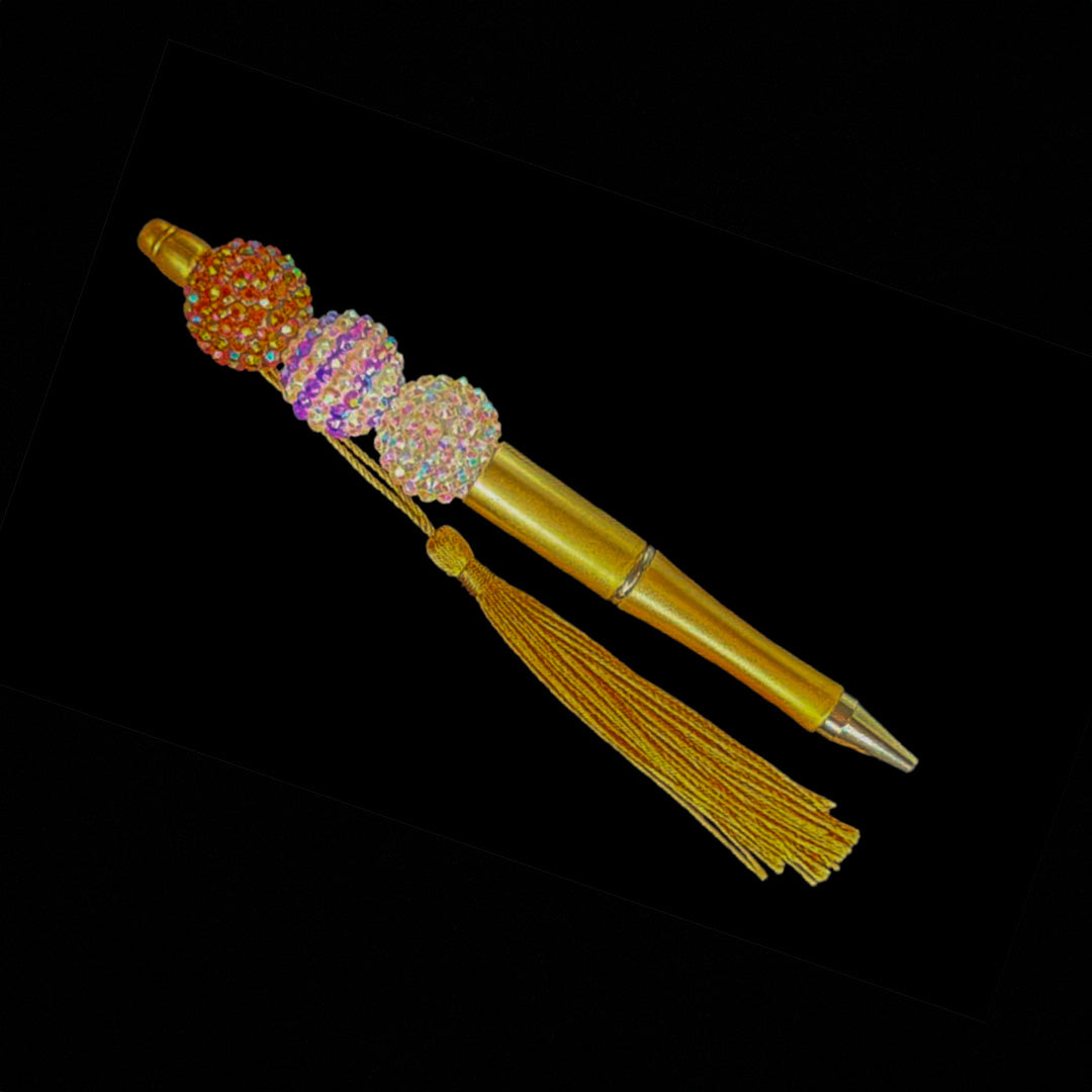 Gold pen with beads and tassel.