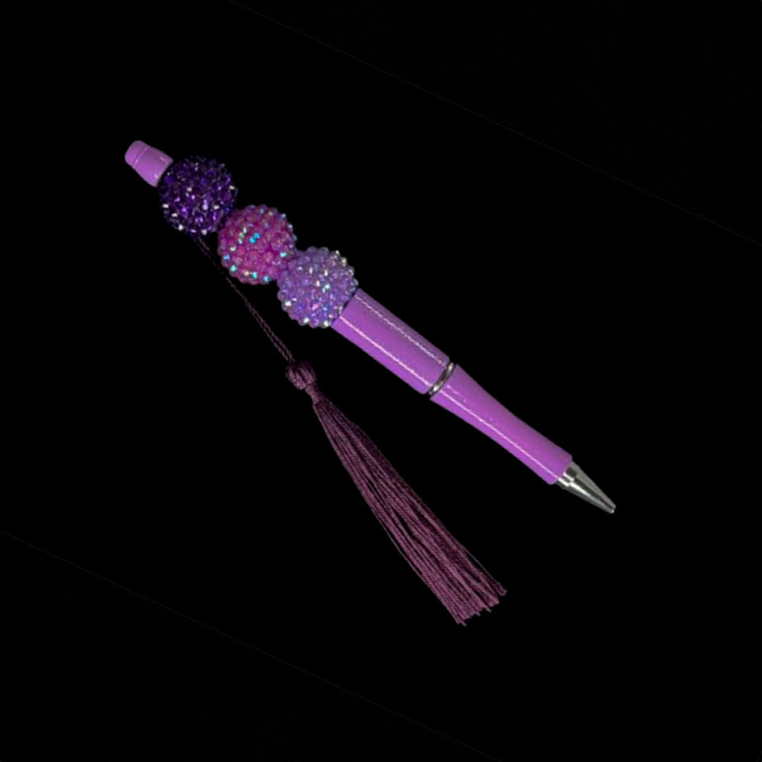 Purple color beaded pen with tassel.